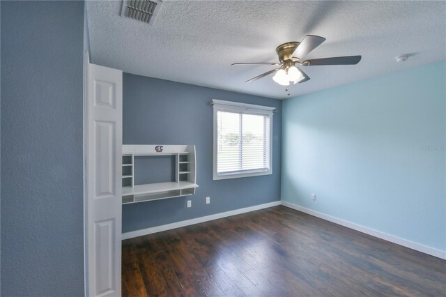 831 Corvina Dr, Davenport, FL 33897 - unfurnished living room featuring dark wood finished floors, a ceiling fan, and a textured ceiling