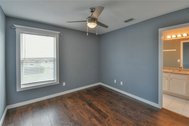 831 Corvina Dr, Davenport, FL 33897 - unfurnished room with a ceiling fan and dark wood-style flooring