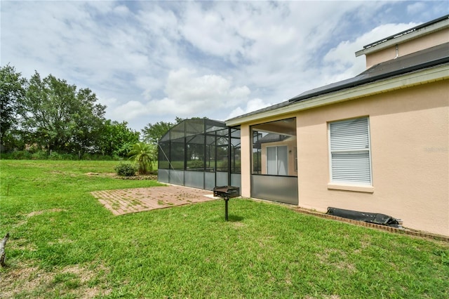 831 Corvina Dr, Davenport, FL 33897 - view of grassy yard featuring a patio area and glass enclosure