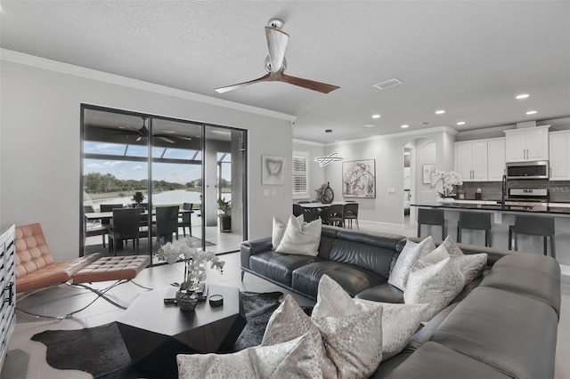 3222 Casterton Dr, Melbourne, FL 32940 - living room featuring crown molding, ceiling fan, arched walkways, and recessed lighting