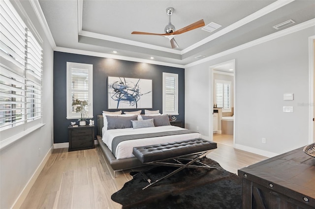 3222 Casterton Dr, Melbourne, FL 32940 - bedroom featuring a tray ceiling, light wood-style flooring, ensuite bathroom, baseboards, and recessed lighting