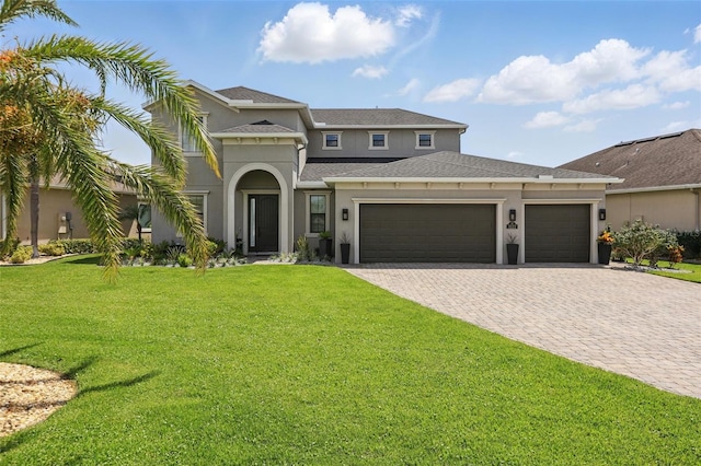 3222 Casterton Dr, Melbourne, FL 32940 - view of front of property featuring an attached garage, stucco siding, a front yard, decorative driveway, and roof with shingles