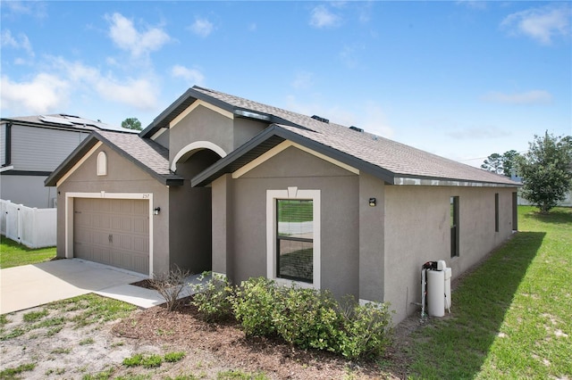 257 Fig Ct, Kissimmee, FL 34759 - single story home with driveway, an attached garage, stucco siding, and a shingled roof