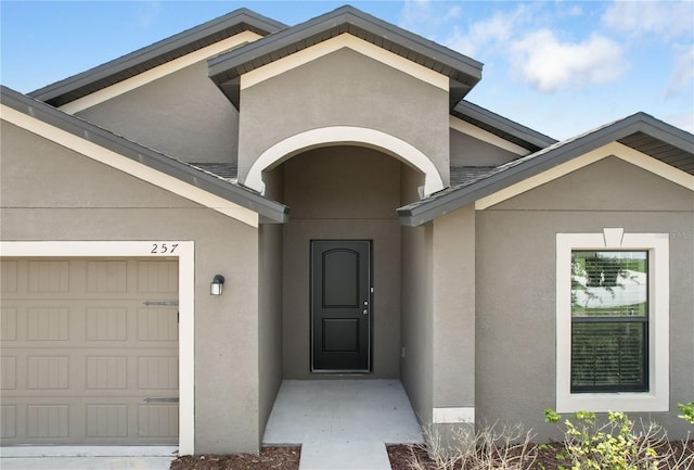 257 Fig Ct, Kissimmee, FL 34759 - entrance to property with stucco siding and a garage