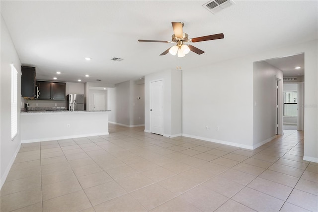 257 Fig Ct, Kissimmee, FL 34759 - unfurnished living room with light tile patterned floors, ceiling fan, and recessed lighting