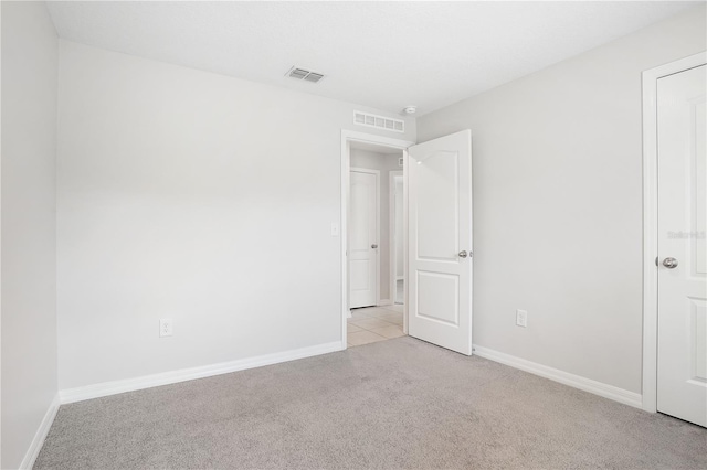 257 Fig Ct, Kissimmee, FL 34759 - unfurnished bedroom with light colored carpet and baseboards