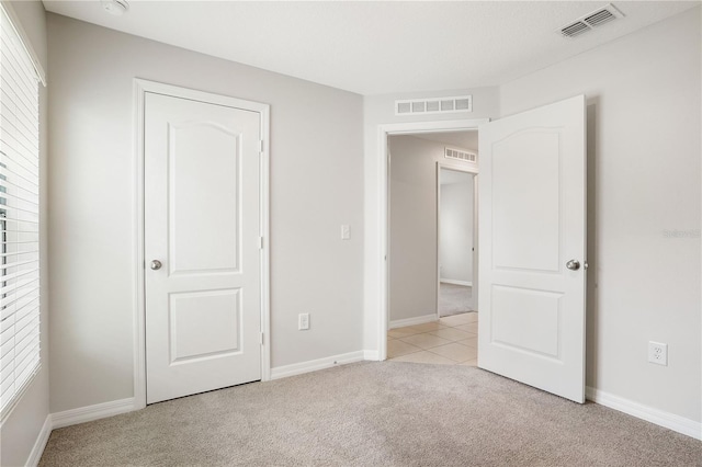 257 Fig Ct, Kissimmee, FL 34759 - unfurnished bedroom with light carpet and baseboards