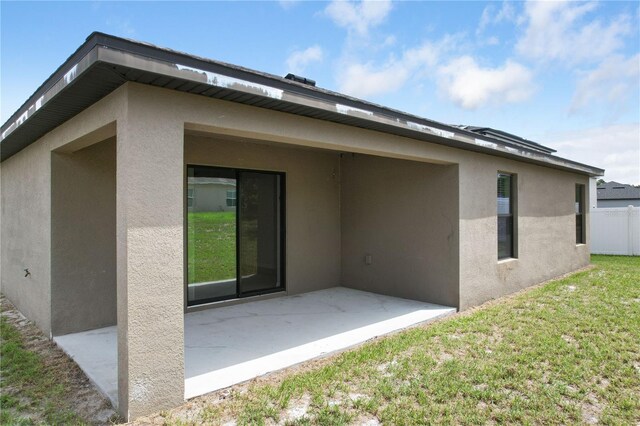 257 Fig Ct, Kissimmee, FL 34759 - back of house with stucco siding and a patio area