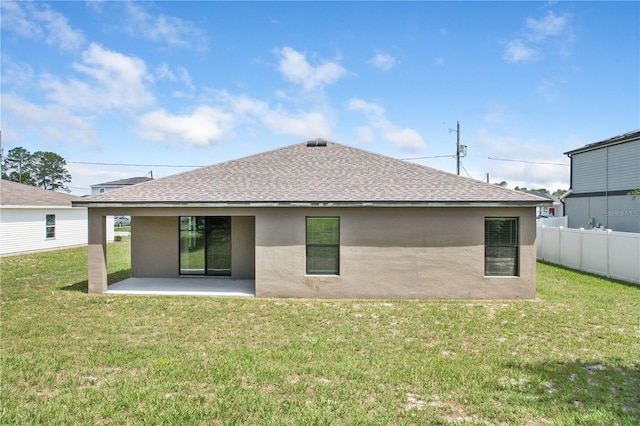 257 Fig Ct, Kissimmee, FL 34759 - back of property featuring stucco siding, roof with shingles, and a patio
