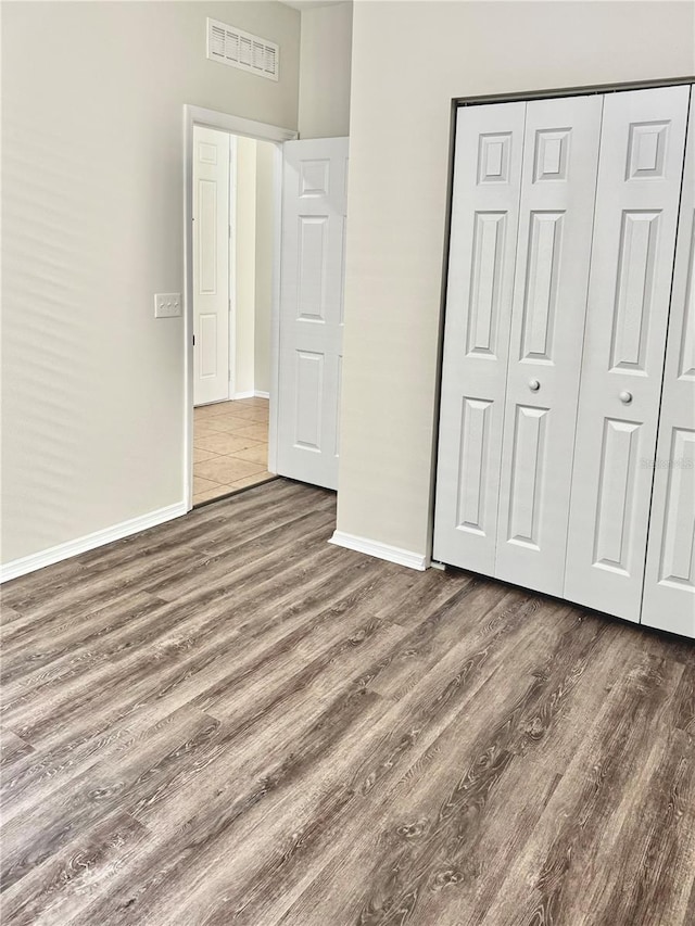 535 Aeolian Dr, New Smyrna Beach, FL 32168 - unfurnished bedroom with wood finished floors and a closet