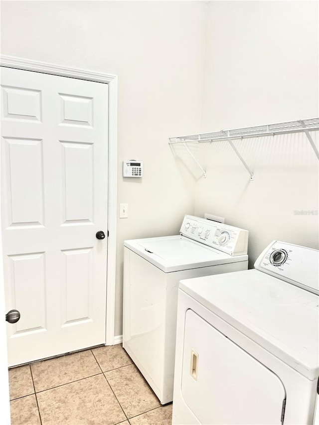 535 Aeolian Dr, New Smyrna Beach, FL 32168 - washroom with washing machine and clothes dryer and light tile patterned floors
