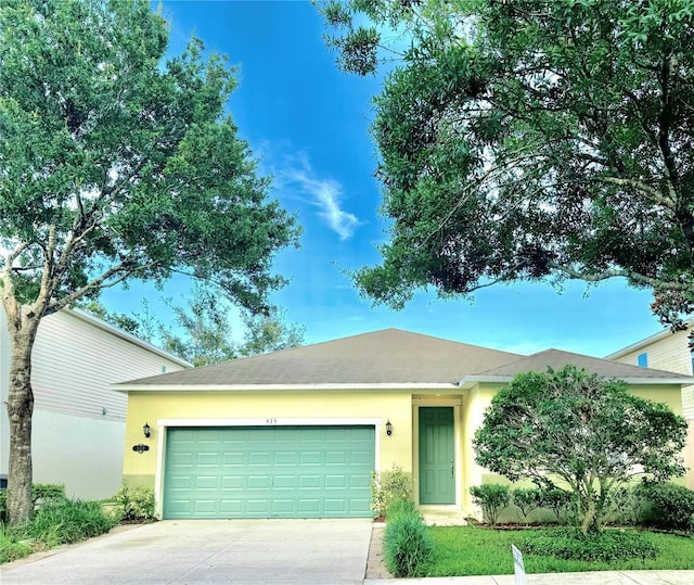 535 Aeolian Dr, New Smyrna Beach, FL 32168 - ranch-style house with concrete driveway, an attached garage, and stucco siding
