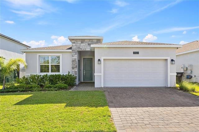3123 Camden Way, Davenport, FL 33837 - view of front of property with stucco siding, decorative driveway, a front lawn, a garage, and stone siding
