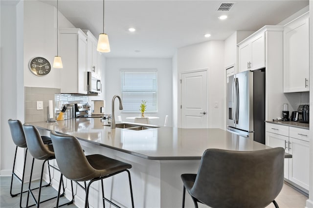 3123 Camden Way, Davenport, FL 33837 - kitchen featuring stainless steel appliances, a sink, a peninsula, tasteful backsplash, and white cabinetry