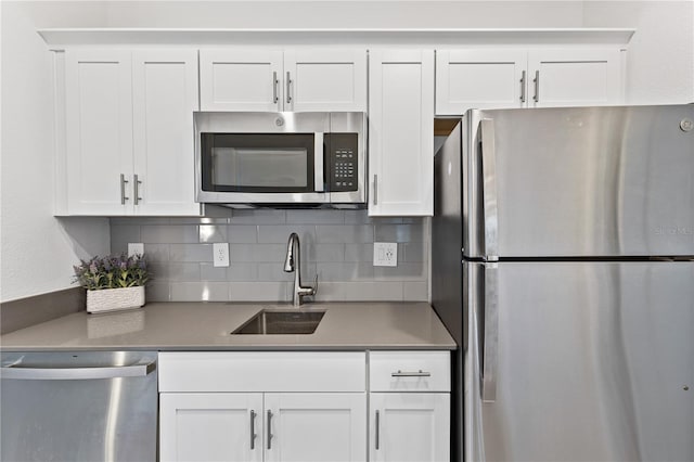 3123 Camden Way, Davenport, FL 33837 - kitchen with stainless steel appliances, a sink, tasteful backsplash, and white cabinets