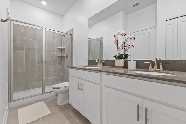 3123 Camden Way, Davenport, FL 33837 - bathroom with double vanity, a stall shower, tile patterned flooring, and toilet