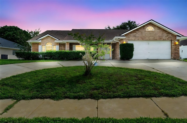 40 Hollow Pine Dr, Debary, FL 32713 - ranch-style home with brick siding, driveway, a garage, a front lawn, and roof with shingles