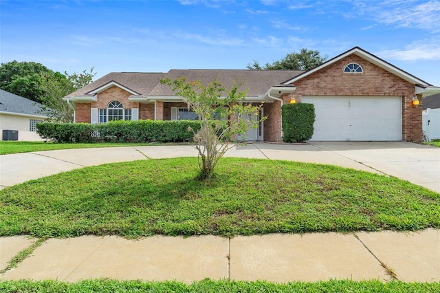 40 Hollow Pine Dr, Debary, FL 32713 - ranch-style home featuring brick siding, concrete driveway, a front yard, a garage, and roof with shingles