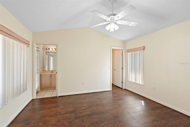 40 Hollow Pine Dr, Debary, FL 32713 - unfurnished bedroom with vaulted ceiling, wood finished floors, ensuite bathroom, ceiling fan, and a textured ceiling