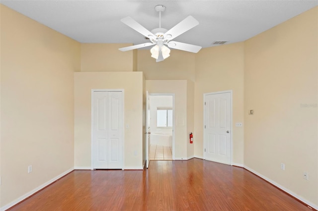 40 Hollow Pine Dr, Debary, FL 32713 - unfurnished bedroom with high vaulted ceiling, wood finished floors, a closet, and a ceiling fan