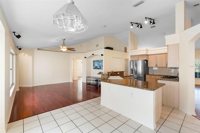 40 Hollow Pine Dr, Debary, FL 32713 - kitchen with appliances with stainless steel finishes, arched walkways, ceiling fan, vaulted ceiling, and light tile patterned flooring