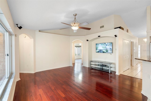 40 Hollow Pine Dr, Debary, FL 32713 - unfurnished living room with arched walkways, a ceiling fan, vaulted ceiling, and wood-type flooring
