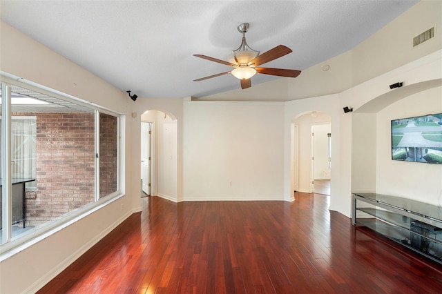 40 Hollow Pine Dr, Debary, FL 32713 - unfurnished living room with lofted ceiling, arched walkways, a ceiling fan, and wood finished floors
