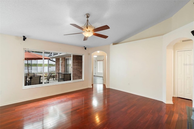 40 Hollow Pine Dr, Debary, FL 32713 - spare room featuring arched walkways, ceiling fan, wood-type flooring, vaulted ceiling, and a textured ceiling