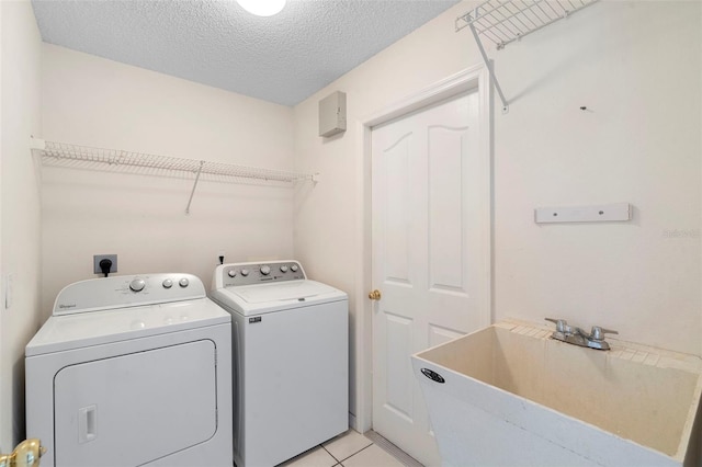 40 Hollow Pine Dr, Debary, FL 32713 - laundry room featuring independent washer and dryer, a textured ceiling, and light tile patterned floors