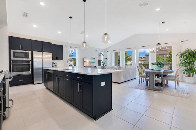 744 Curly Locks Loop, Apopka, FL 32703 - kitchen featuring stainless steel appliances, lofted ceiling, dark cabinets, light countertops, and a chandelier