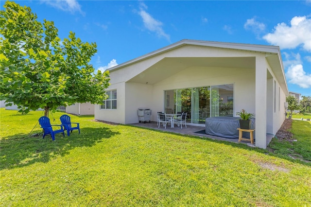 744 Curly Locks Loop, Apopka, FL 32703 - back of house featuring stucco siding, a lawn, and a patio area
