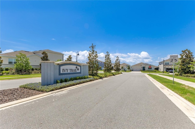 744 Curly Locks Loop, Apopka, FL 32703 - view of asphalt road featuring traffic signs, curbs, a residential view, sidewalks, and street lighting