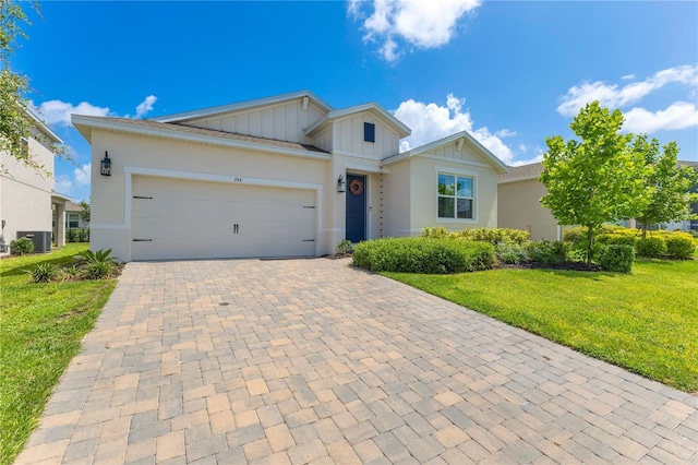 744 Curly Locks Loop, Apopka, FL 32703 - single story home with board and batten siding, decorative driveway, a front yard, a garage, and stucco siding
