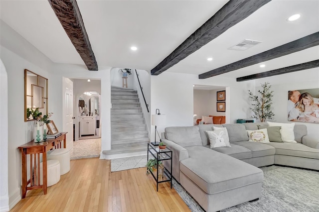 322 Cornell Dr, Lake Worth, FL 33460 - living room featuring stairs, beam ceiling, light wood finished floors, recessed lighting, and arched walkways