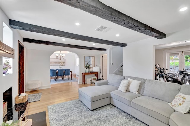 322 Cornell Dr, Lake Worth, FL 33460 - living area featuring arched walkways, beam ceiling, stairway, light wood-type flooring, and recessed lighting