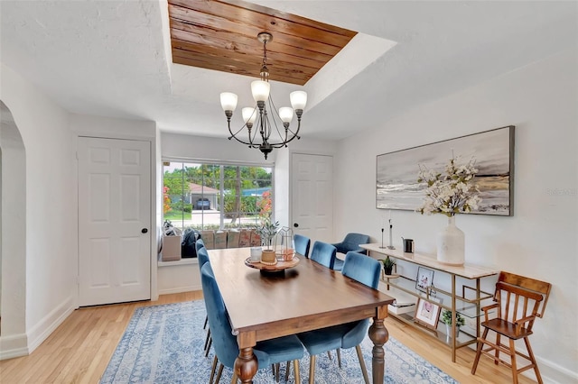 322 Cornell Dr, Lake Worth, FL 33460 - dining room featuring arched walkways, baseboards, light wood finished floors, a chandelier, and wood ceiling