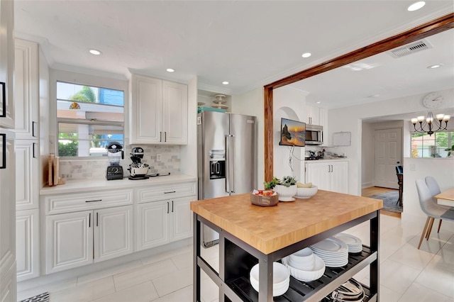 322 Cornell Dr, Lake Worth, FL 33460 - kitchen featuring stainless steel appliances, light tile patterned flooring, tasteful backsplash, plenty of natural light, and recessed lighting