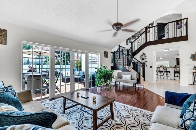 19367 NW 13th St, Pembroke Pines, FL 33029 - living room with healthy amount of natural light, ceiling fan, stairs, wood finished floors, and a textured ceiling