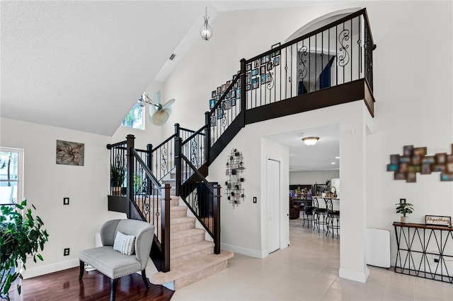 19367 NW 13th St, Pembroke Pines, FL 33029 - stairs featuring high vaulted ceiling, baseboards, and plenty of natural light