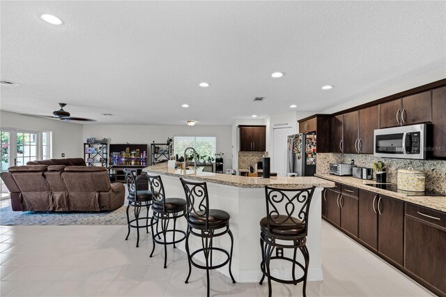 19367 NW 13th St, Pembroke Pines, FL 33029 - kitchen featuring appliances with stainless steel finishes, plenty of natural light, a breakfast bar, a kitchen island with sink, and recessed lighting