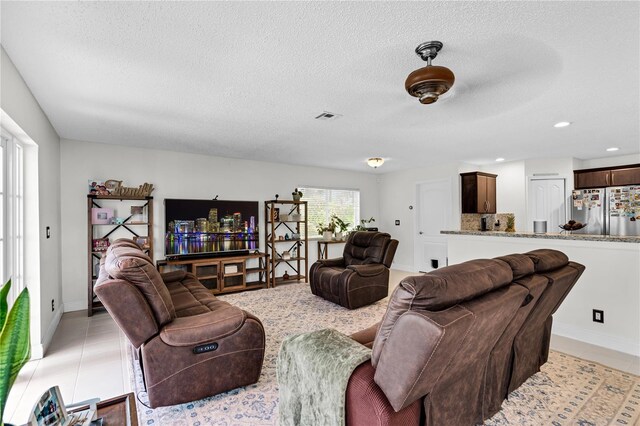 19367 NW 13th St, Pembroke Pines, FL 33029 - living area featuring a textured ceiling, recessed lighting, baseboards, and light tile patterned floors