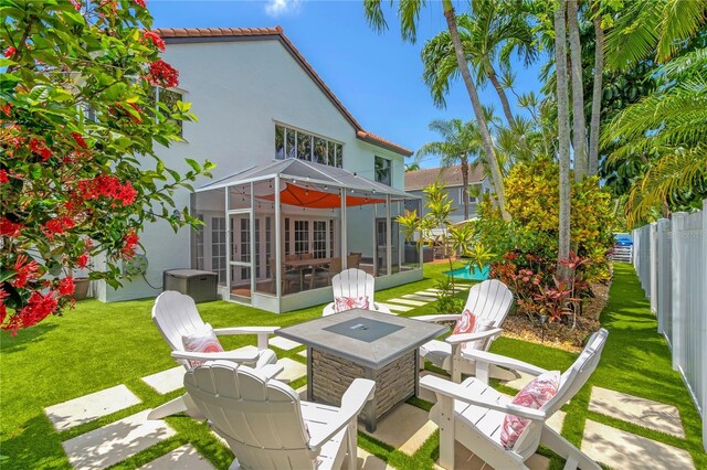 19367 NW 13th St, Pembroke Pines, FL 33029 - back of house featuring a sunroom, stucco siding, a patio area, and an outdoor fire pit