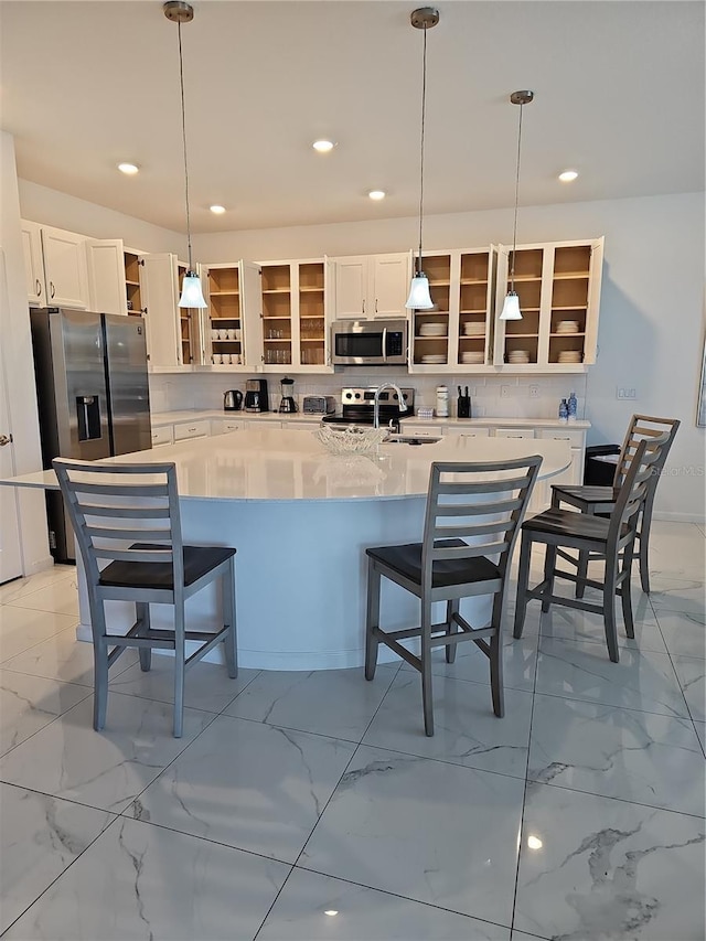 2496 Rama Dr, Kissimmee, FL 34746 - kitchen with open shelves, appliances with stainless steel finishes, light marble finish flooring, a sink, and white cabinets