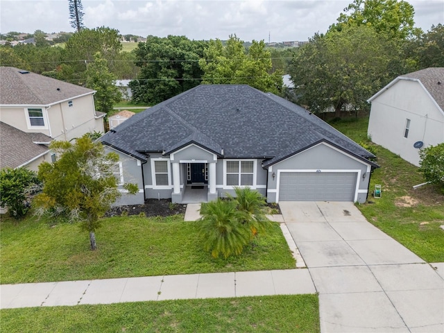1780 Nature Cove Ln, Clermont, FL 34711 - ranch-style home with a shingled roof, an attached garage, concrete driveway, and a front lawn