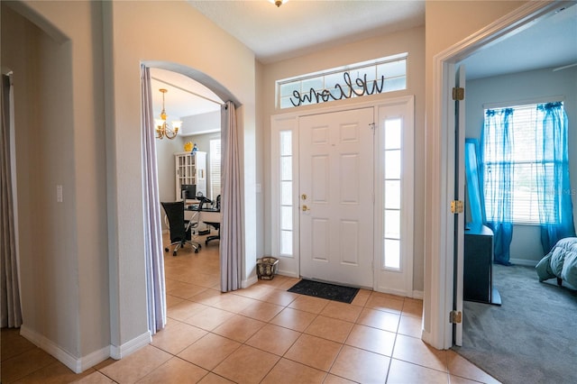 1780 Nature Cove Ln, Clermont, FL 34711 - entrance foyer with light tile patterned floors, arched walkways, and a chandelier