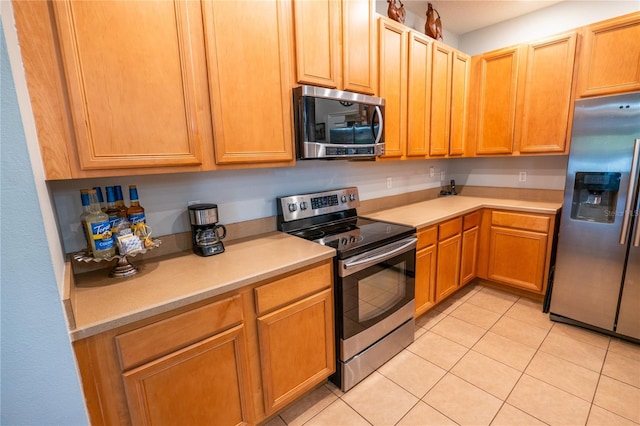 1780 Nature Cove Ln, Clermont, FL 34711 - kitchen featuring stainless steel appliances, light countertops, and light tile patterned floors