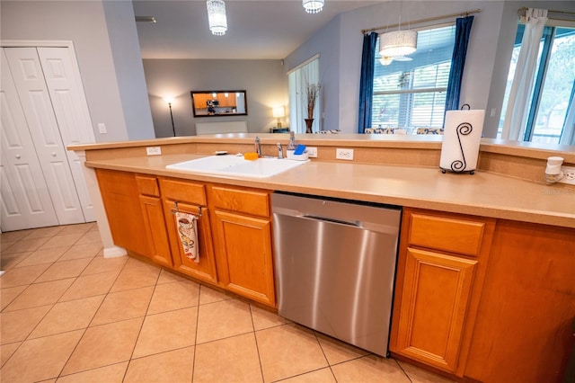 1780 Nature Cove Ln, Clermont, FL 34711 - kitchen featuring stainless steel dishwasher, light tile patterned floors, light countertops, pendant lighting, and brown cabinetry