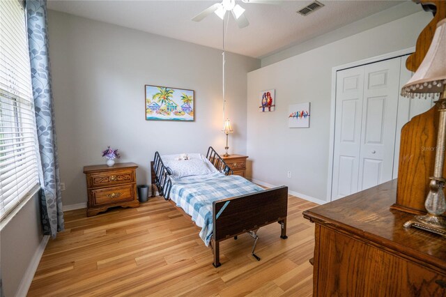 1780 Nature Cove Ln, Clermont, FL 34711 - bedroom with light wood-style floors, a closet, and ceiling fan