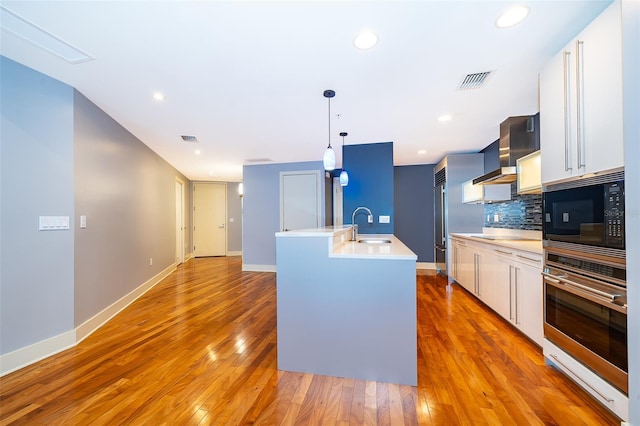 260 S Osceola Ave Unit 710, Orlando, FL 32801 - kitchen featuring appliances with stainless steel finishes, light countertops, decorative backsplash, white cabinetry, and recessed lighting