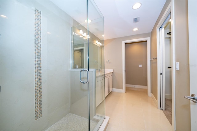 260 S Osceola Ave Unit 710, Orlando, FL 32801 - bathroom with vanity, recessed lighting, a shower with shower door, a walk in closet, and tile patterned flooring